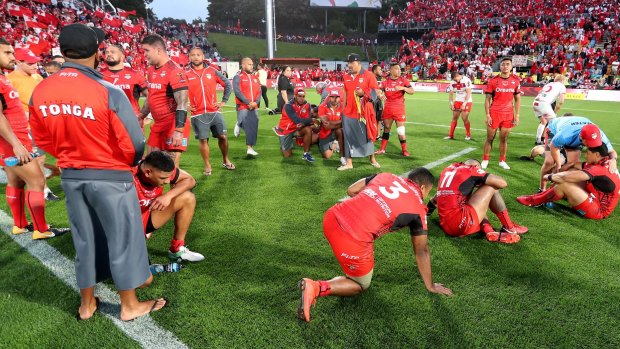 Dejected: Tonga players react after the final whistle.