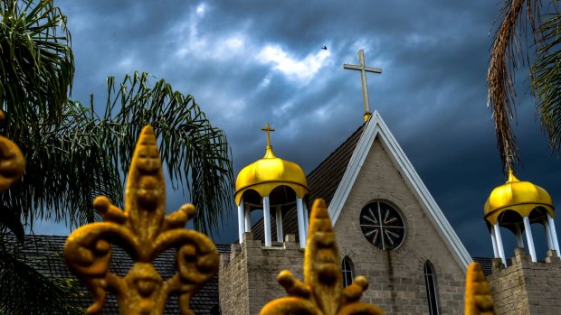 Storm clouds gather over St Zaia Cathedral, Middleton Grange in Sydney's western suburbs.