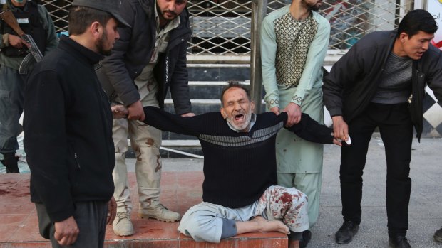 A relative of a victim is cries after a deadly suicide attack in Kabul, Afghanistan.