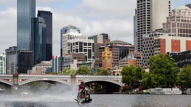 Robbie Maddison rides his modified motorbike along the surface of the Yarra.