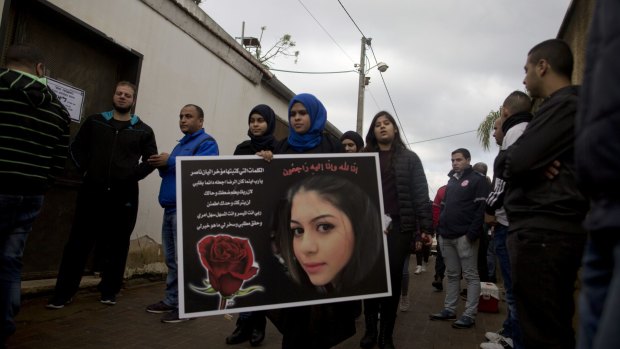 A friend holds a placard with a picture of Arab Israeli Leanne Nasser during her funeral on January 3, 2017 in Tira, Israel. 