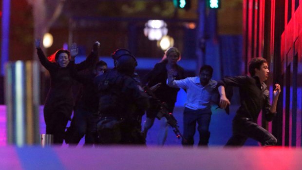 Hostages run from the Lindt cafe on the night of the siege.