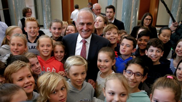 Malcolm Turnbull meets children in the Parliament House foyer after addressing the public service on Wednesday. 