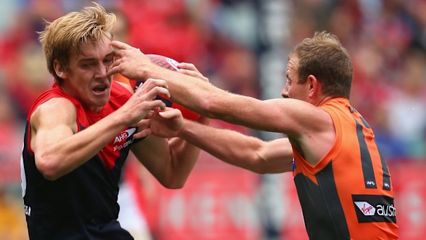 Tough at the ball: Steve Johnson challenges Demon Oscar McDonald.