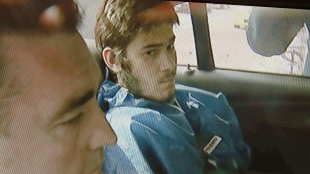 Sevdet Besim in the back of a police car after his arrest.