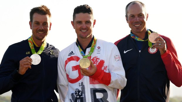 Justin Rose, centre, with his gold medal, flanked by Henrik Stenson, left, and Matt Kuchar.
