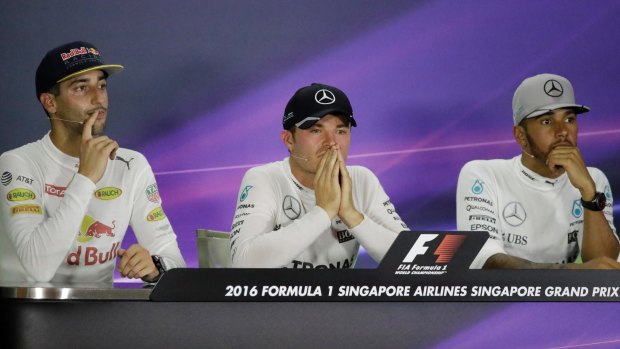 Race winner Mercedes driver Nico Rosberg, centre, of Germany sits with second placed Red Bull driver Daniel Ricciardo, left, of Australia and teammate and third placed Lewis Hamilton.