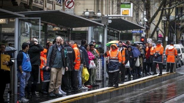 Passengers wait at a tram stop during the last strike. 