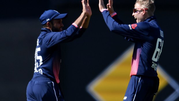 Joe Root and Adil Rashid celebrate the dismissal of Travis Head, caught and bowled by the England skipper.