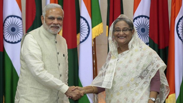 Indian Prime Minister Narendra Modi and Bangladeshi Prime Minister Sheikh Hasina shake hands in Dhaka, Bangladesh.