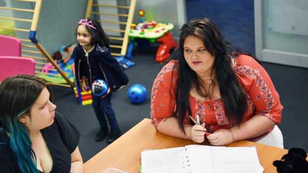 Tnaysha Halemba, right, in her year 12 class with daughter Leyarna and another young mother, Taylor Gunther.