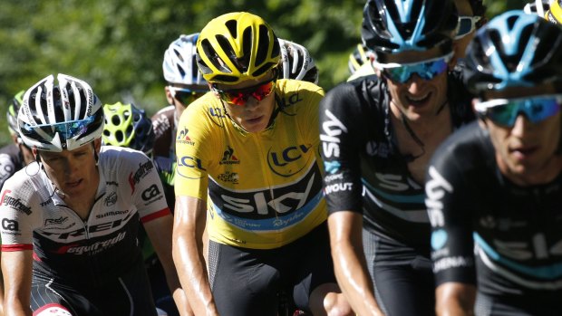Chris Froome's ever-present Sky train sets the pace for the yellow jersey.