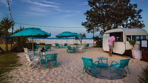 The new Beach Club at Elements of Byron offers more loungers with umbrellas, a gathering of tables and chairs and a bar in a caravan serving all-day drinks.