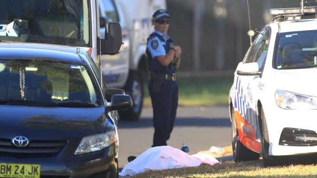 A police officer at the scene of the Ingleburn shooting, guarding what appeared to be a body.