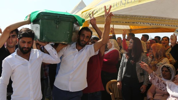 Defiance at a mass funeral service  for victims of the Gaziantep attack.