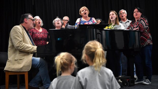 Beth Rankin and Warren Wills (far left) with Choir of Hard Knocks singers during rehearsals. 