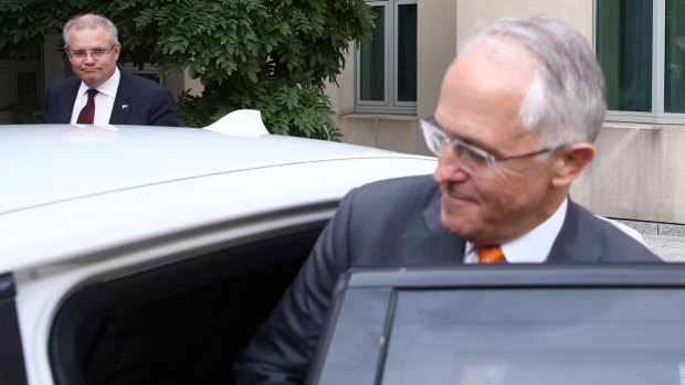 Here's looking at you ... Treasurer Scott Morrison looks on as PM Malcolm Turnbull cuts short their 'photo opportunity' exit following the COAG meeting.
