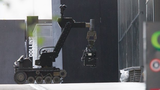 A bomb squad robot investigates the package that turned out to be a pair of shoes.