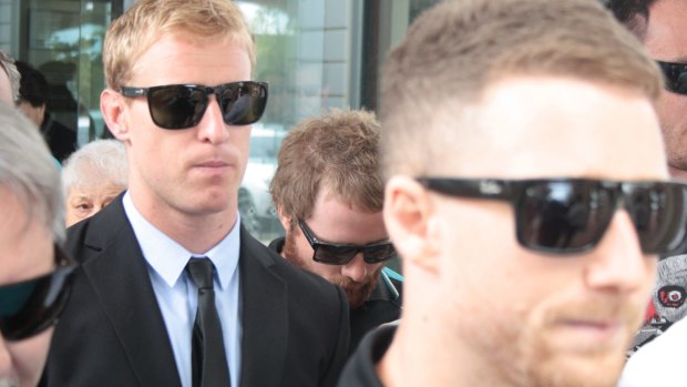 Matt Blackford (in suit) leaves court after being found guilty of an on-field assault.