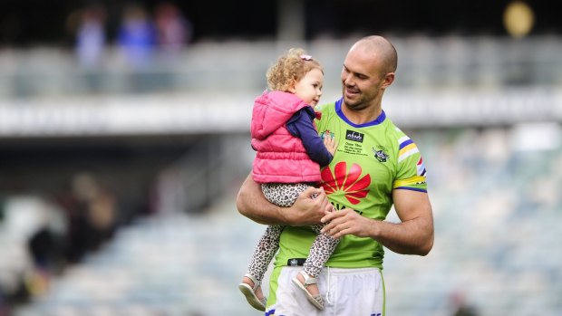 Canberra Raiders player Dane Tilse with daughter Ila after playing his 200th game and his last home game for the Canberra Raiders. 