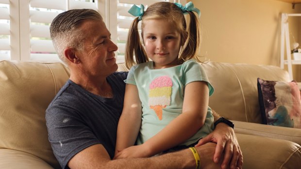 Isla, who has finished treatment and is doing well, with her father Darrin Batchelor. 