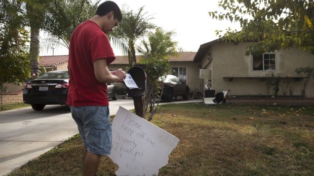A brother of Enrique Marquez collects his mail in Riverside, California. 