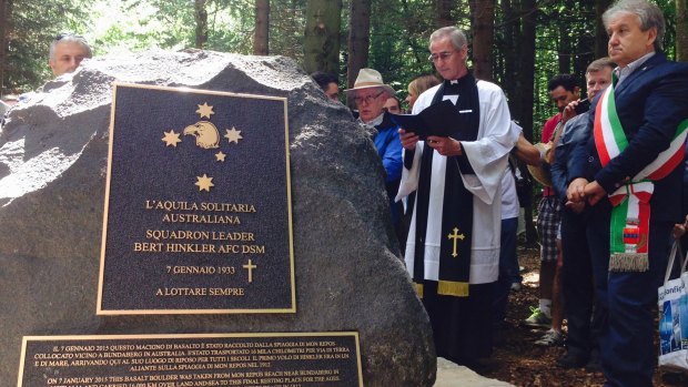 A priest leads a ceremony at the unveiling of a memorial dedicated to the Australian aviator Bert Hinkler.