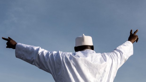Gambian President Adama Barrow gestures to supporters as he arrives at Banjul International Airport.
