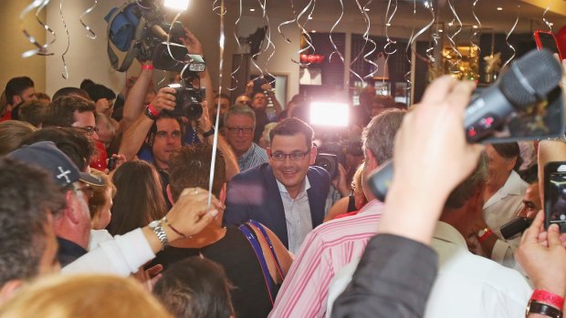 Labor supporter surround Daniel Andrews as he moves to the stage to make his victory speech.