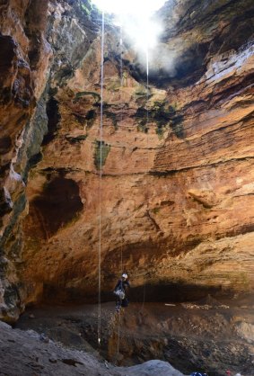 Expedition co-leader Alan Cooper abseils into the cave.