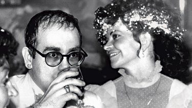 Elton John sipping on champagne at his wedding marriage