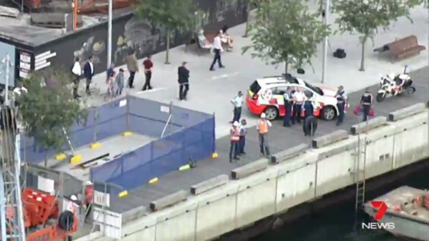 Police and emergency services attend the scene of a workplace accident on a barge at Barangaroo.