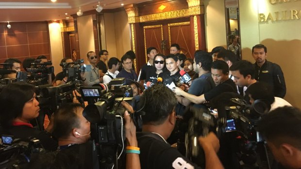 Thailand coach Kiatisuk Senamuang is swarmed by media at the team hotel.