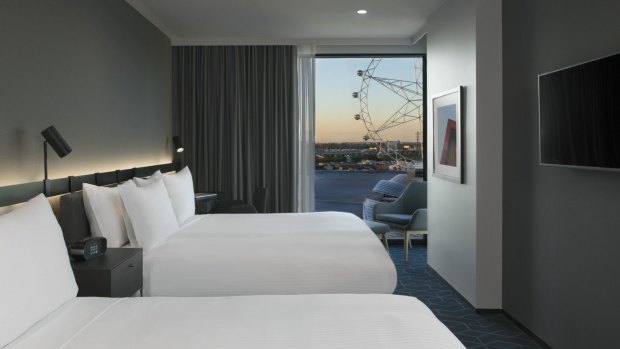 A premium double bedroom looks out to the Melbourne Star Observation Wheel.