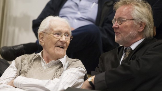 Oskar Groening and his lawyer Hans Holtermann during the first day of his trial.