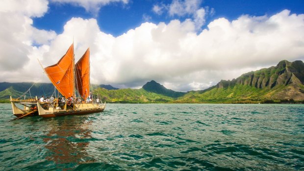 The day breaks over Hokulea with Kualoa behind her. 