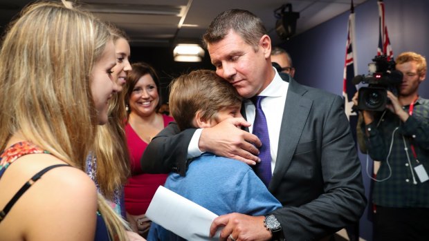 Premier Mike Baird embraces his family after Thursday's press conference where he announced his resignation.
