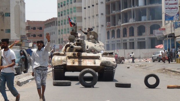 Militia loyal to Yemen's President Abed Rabbu Mansour Hadi take positions at a street in Aden on April 2.