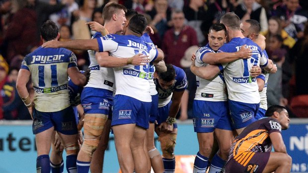 Big surprise: Bulldogs players celebrate beating the Broncos in Brisbane.