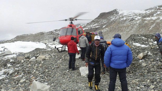 People are examined for injuries and prepared for helicopter evacuation at the Everest base camp on Sunday.