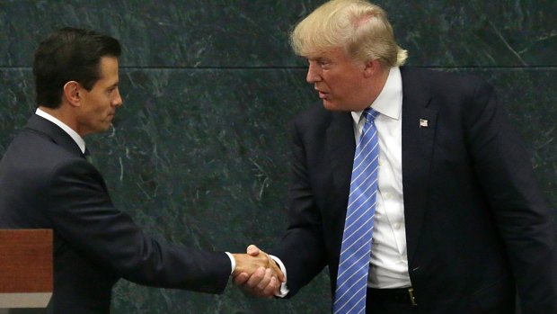 This makes things ok, right? Mexican President Enrique Pena Nieto and Republican presidential nominee Donald Trump shake hands.