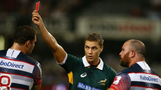 Referee Jaco van Heerden shows a red card to Laurie Weeks of the Melbourne Rebels.