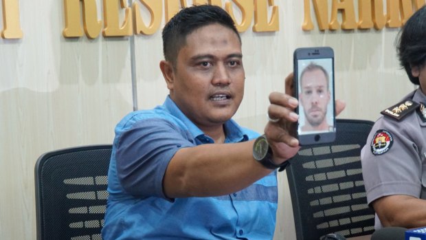 The deputy director of narcotics for Bali police, Sudjarwoko, holds a photo of Joshua James Baker.