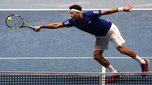 Brilliant display: France's Jo-Wilfried Tsonga stretches for a volley.