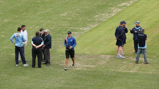 Game over: Match referee Steven Bernard discusses the abandonment of the Sheffield Shield match with NSW sdkipper Moises Henriques.