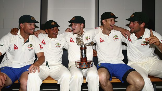 Happy bunch: (from left) David Warner, Usman Khawaja, Steve Smith, Adam Voges and Joe Burns celebrate with the Trans-Tasman Trophy.