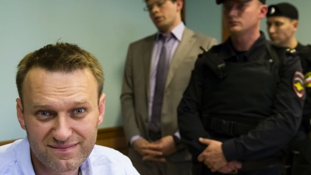 Russian opposition leader Alexei Navalny, left, sits during a hearing over his arrest in Moscow on June 16.
