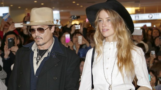 Amber Heard and Johnny Depp, pictured in 2015, will settle their divorce case.