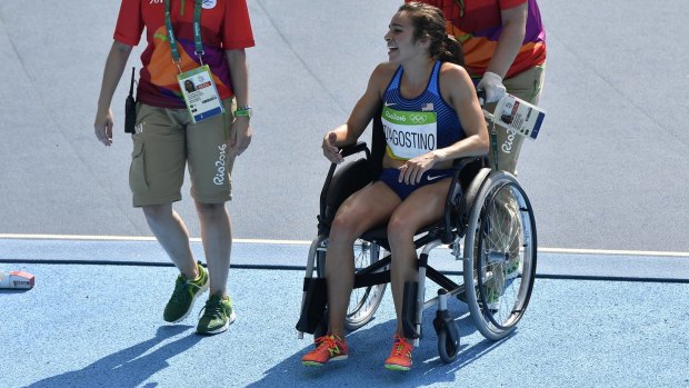 Abbey D'Agostino is helped from the track in a wheelchair