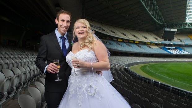 Michael Yates and Chantelle Schembri toast their Etihad Stadium wedding.